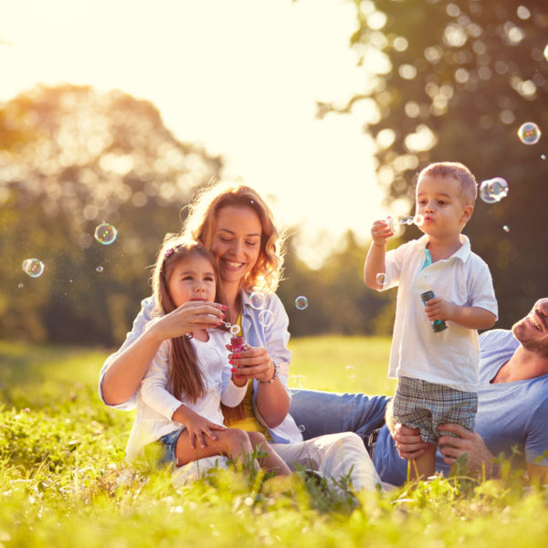 Family,With,Children,Blow,Soap,Bubbles,Outdoor